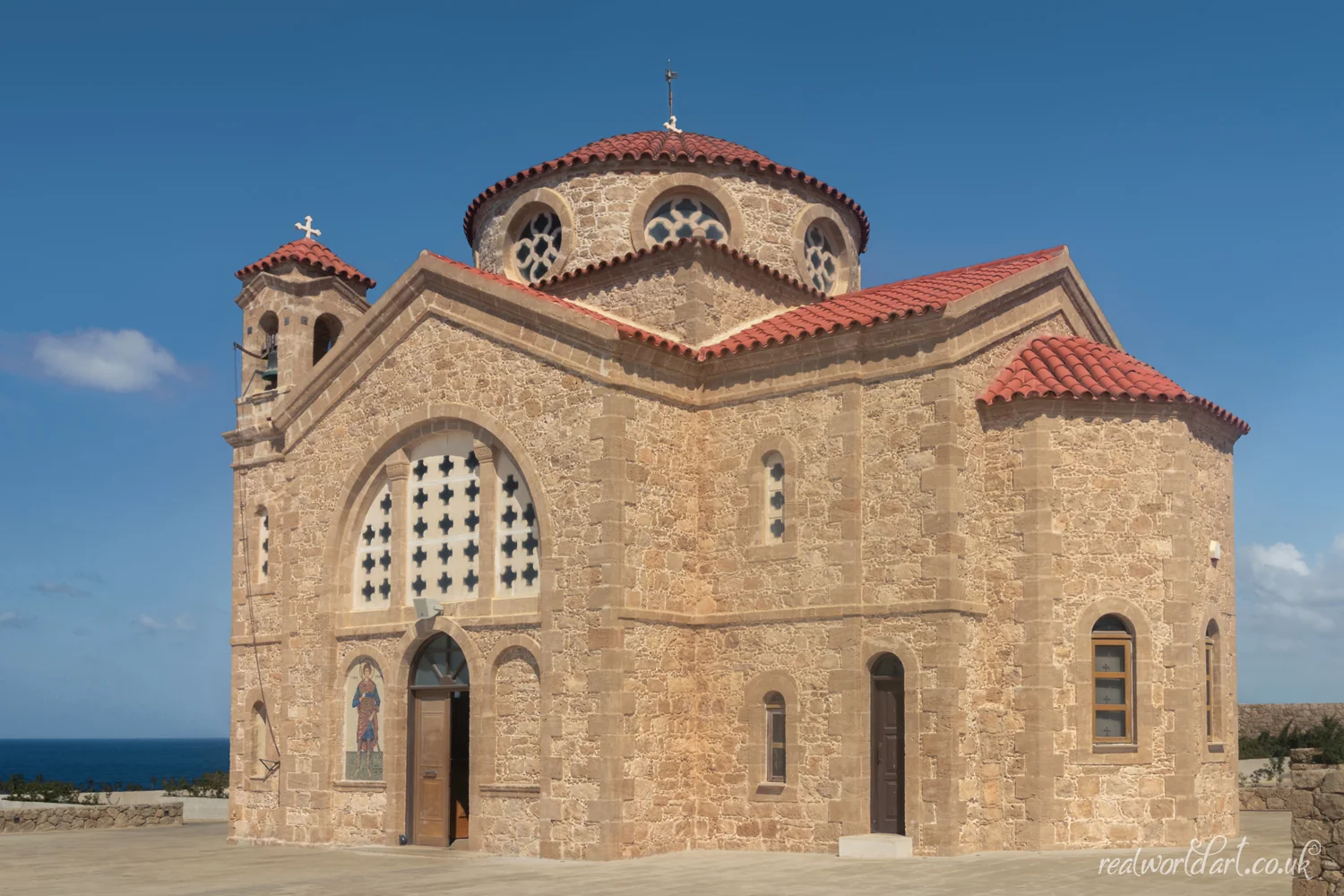 Framed Wall Art: A stone church with red tiled roof under a clear blue sky taken at Agios Georgios Church, Agios Georgios, Cyprus 