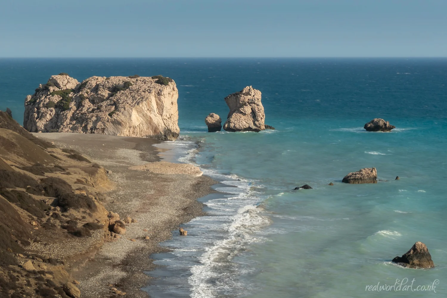 Greeting Cards: A wide view of a large rock formation rising from turquoise Mediterranean water taken at Aphrodite&rsquo;s Beach, Kouklia, Cyprus 