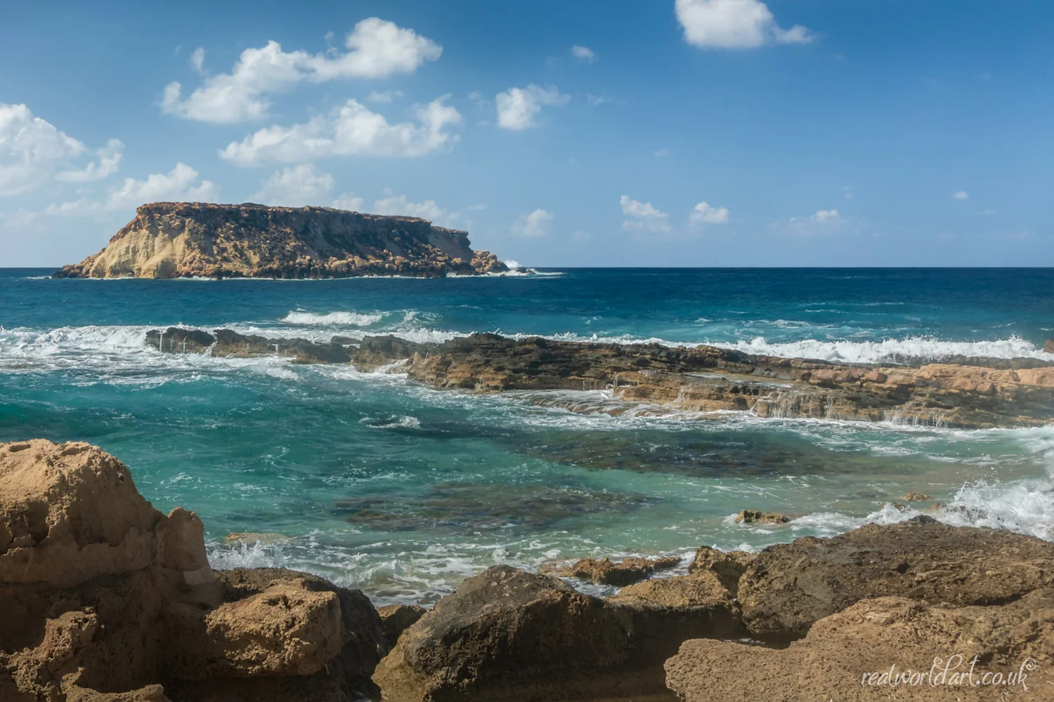 Greeting Cards: A rocky shoreline and turquoise sea with Geronisos Island on the horizon taken at Agios Georgios Beach, Agios Georgios, Cyprus 