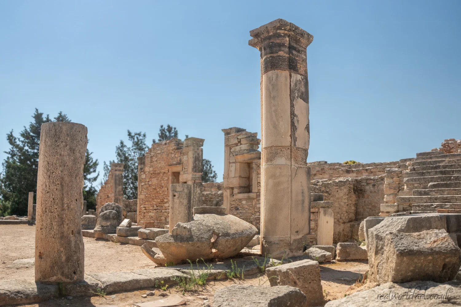Art Prints: Ancient stone columns and scattered ruins at an archaeological site in bright sunlight taken at Sanctuary of Apollo Hylates, Episkopi, Cyprus 