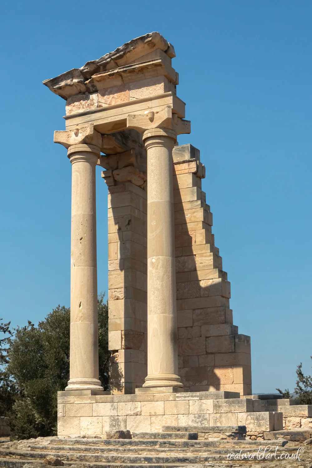 Art Prints: A partially reconstructed classical temple with tall stone columns against a clear blue sky taken at Sanctuary of Apollo Hylates, Episkopi, Cyprus 